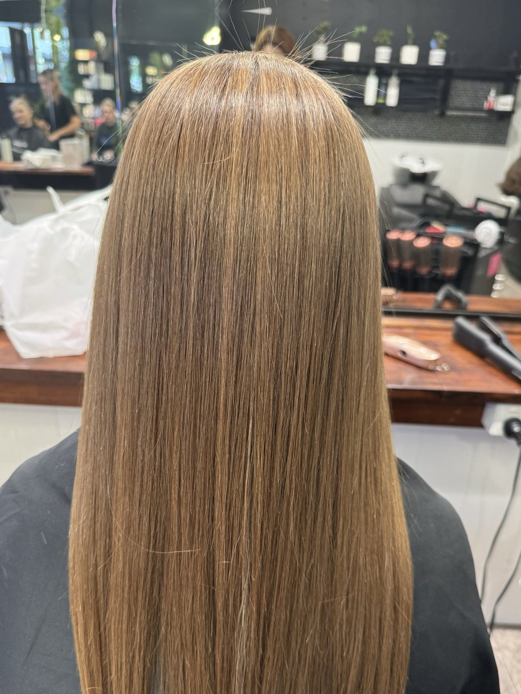 The same hair after treatment — smooth and glossy