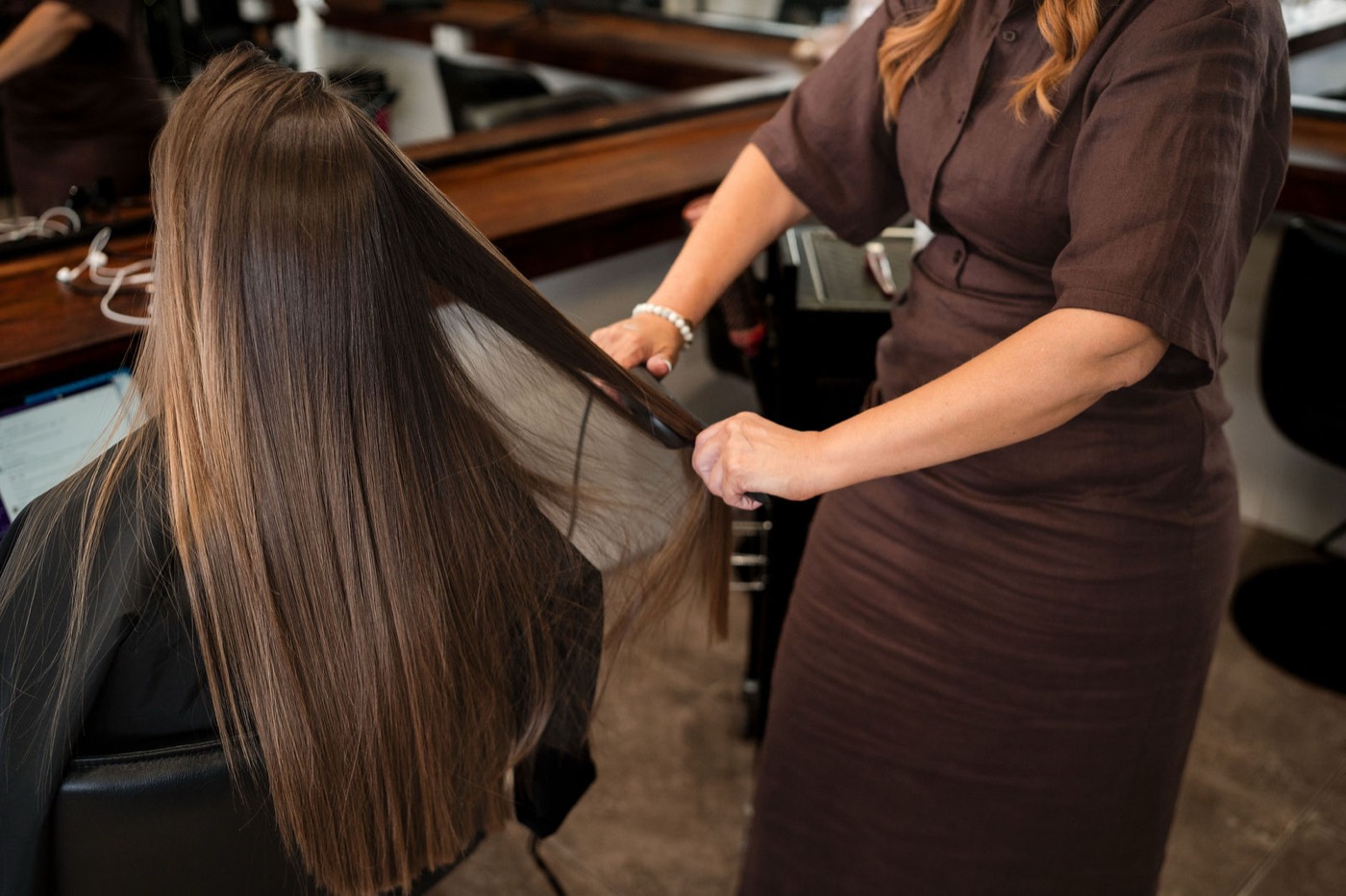 A sheet of freshly smoothed hair held out